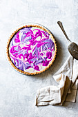 A marbled dragon fruit and purple beet tart