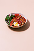 British breakfast bowl with serrano ham and poached egg