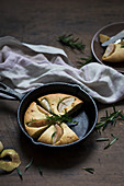 Pancake with pears and rosemary, baked in a cast iron skillet