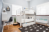 White bunk beds with storage drawer below in children's bedroom