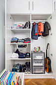 Boy's clothing in wardrobe with open doors