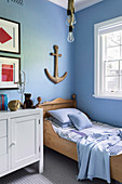 Maritime children's room with light blue wall and anchor