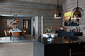 Modern log cabin with open doorway between kitchen and dining room