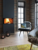Roaring fire in modern fireplace in log cabin