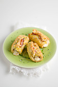 Breaded turkey rolls with smoked ham and scamorza filling