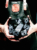 A man holding charcoal