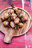 Grilled potatoes in bacon with rosemary and chilli garlic oil