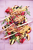 Poultry and lemongrass skewers with grilled fruit salad