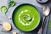 Spinach soup with cream in a bowl