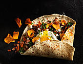 Burrito with chard, pinto beans, chorizo, fried egg, and sweet potato chips