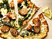 Flatbread pizza with sausage and broccolini