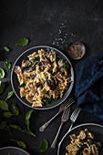 Pasta dish with mushrooms, parsley, cream, garlic, spinach and cheese, plated