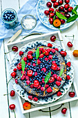 Summer fruit tart with berries, apricots and cherries