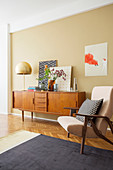 Armchair and retro sideboard in living room