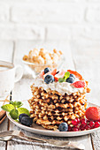 Belgian waffles with cream and fresh berries
