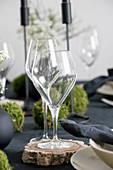 Wine glasses on wooden coasters on set table