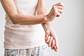 Woman applying an oestrogen gel on her hands