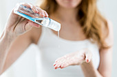 Woman washing her hands with hydroalcoholic gel