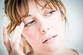 Woman touching her eyelid