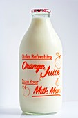 Bottle of semi-skimmed milk advertising fresh orange juice