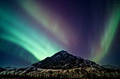 Aurora over a mountain range in Alaska