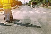 Worker painting pedestrian crossing