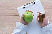 Doctor advising apple instead of pills