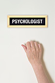 Female hand knocking on psychologist's door