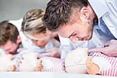 Doctors practising infant CPR