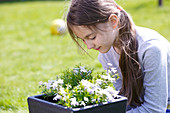 Girl examining plant