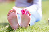 Girls' bare feet on grass