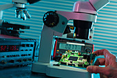 Examining circuit board with microscope