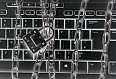 Computer keyboard with metal chains and padlock