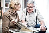 Senior couple looking at photo album