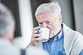 Senior man drinking mug of tea