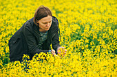 Farmer examining oil seed rape crop