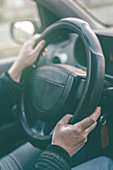 Driver's hands on steering wheel