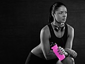 Woman holding pink sports bottle