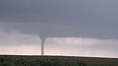 Tornado and hailstones over rural landscape, USA