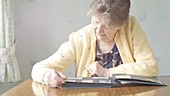 Elderly woman with photo album