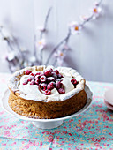 Pistachio and raspberry cake with meringue, whipped cream, icing sugar