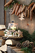 Garland of fir cones above candle lantern in wreath of birch branches