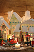 Illuminated Christmas village of pastel cardboard houses