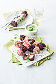 Carpaccio and feta cheese skewers with black and white sesame seeds