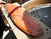 A salmon side on a wooden plank for grilling