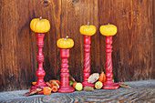 Small pumpkins on candlesticks