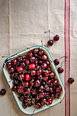 Fresh cherries in an enamel tray