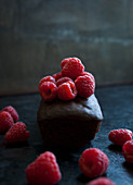 A chocolate cake topped with raspberries