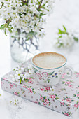 Cup of coffee and cherry blossom