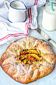 Rustic pie with peaches and pistachios